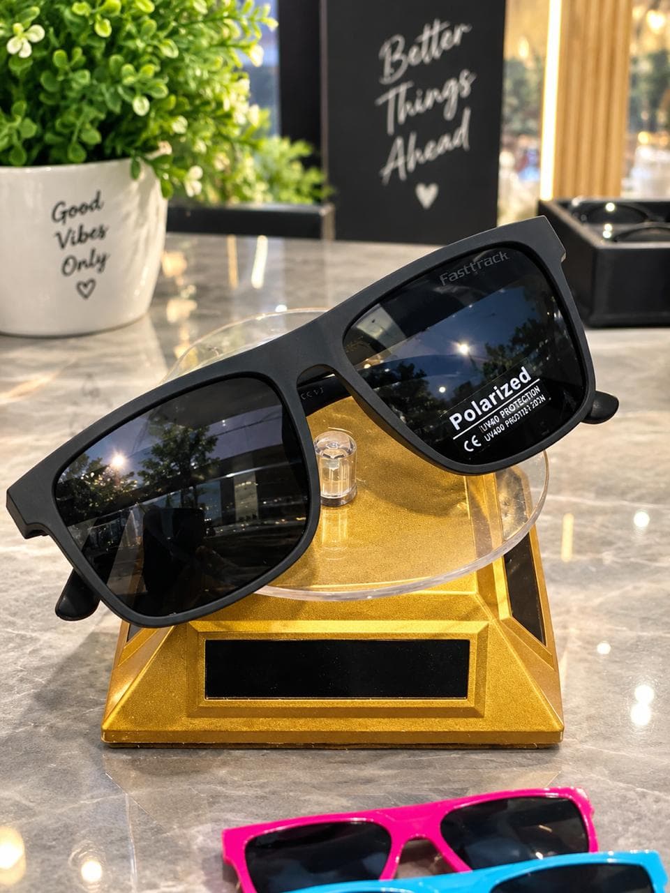 Black polarized sunglasses held outdoors